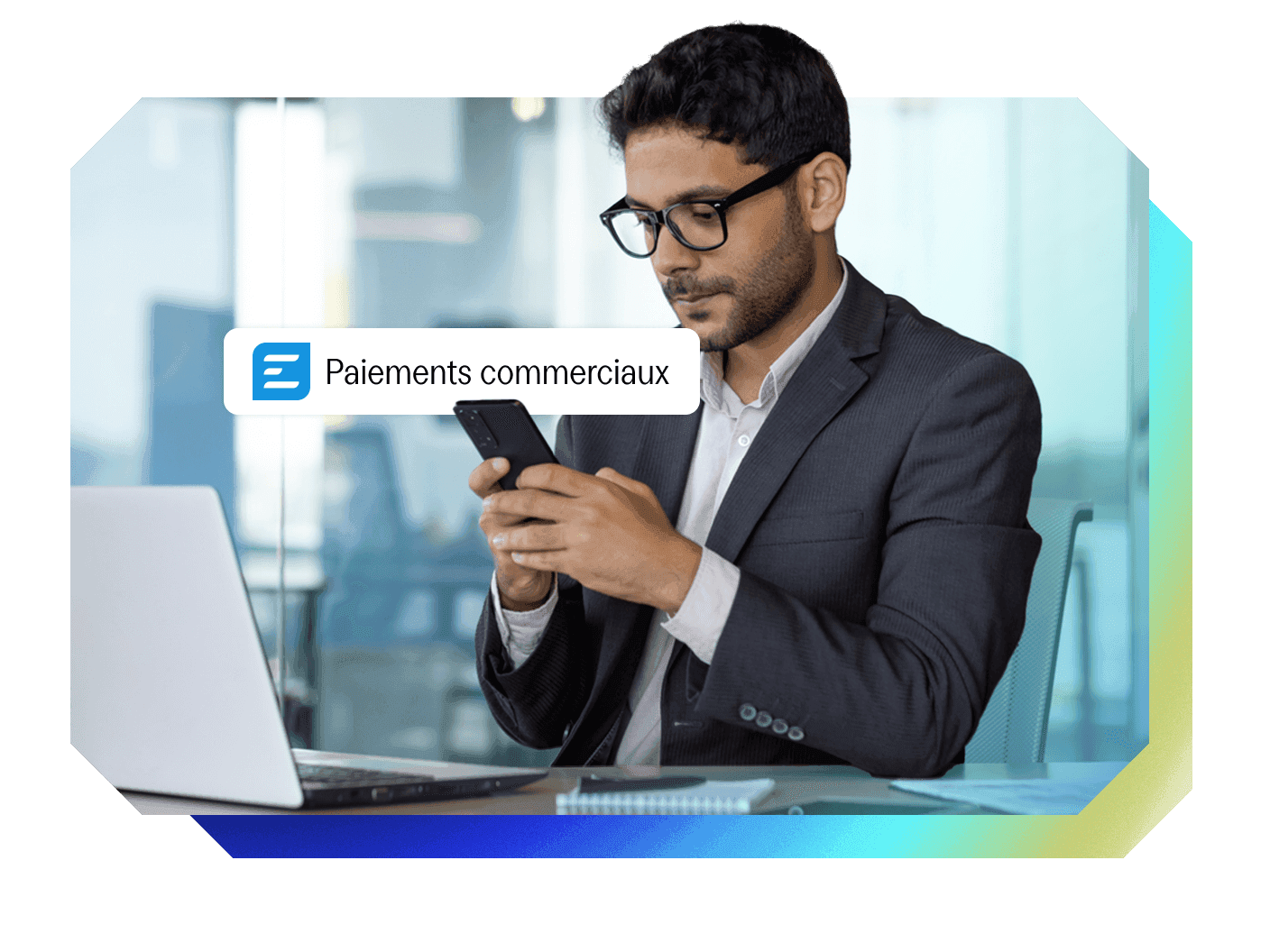 A man in a suit looks at his smartphone, with a notification "Paiements commerciaux" (Commercial payments) and a logo with three horizontal lines. A laptop is on his desk.