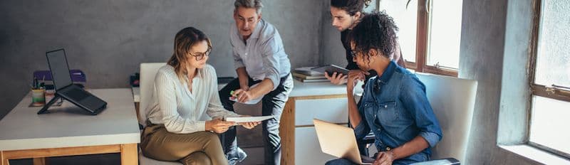 Group of people discussing how to implement Emburse solutions to their industry