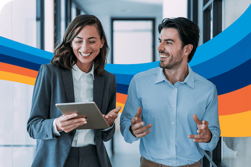 a man and a woman are looking at a tablet together