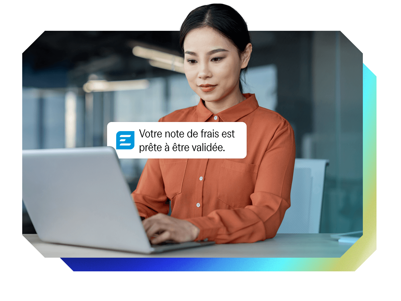 A woman works on a laptop, receiving a notification that her expense report is ready for validation.