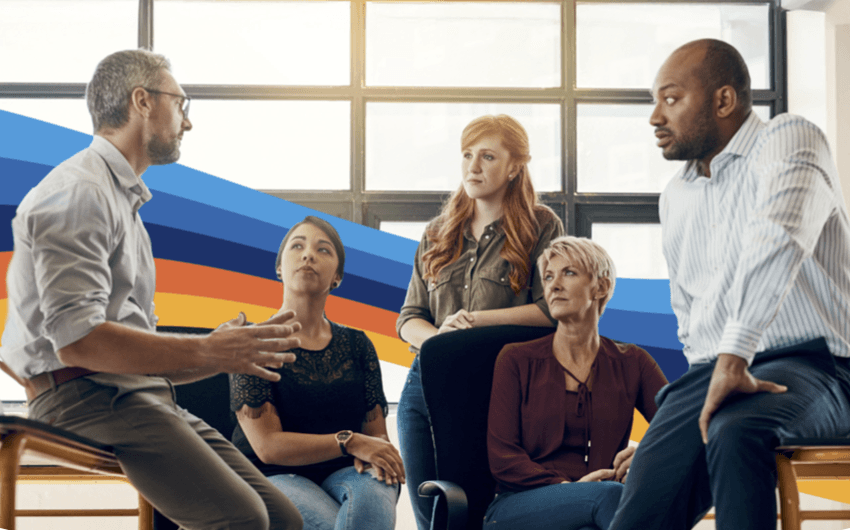 a group of people are sitting in chairs having a conversation