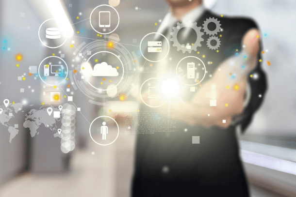 A blurred business person interacting with a glowing digital network of cloud, database, and global map icons.