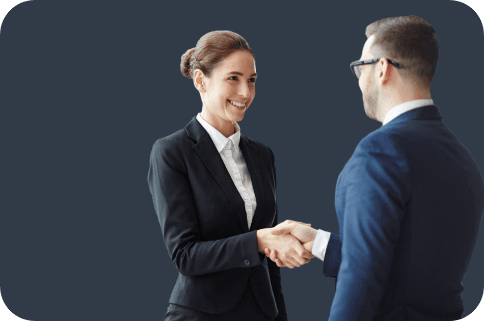 a woman in a suit shakes hands with a man in a suit