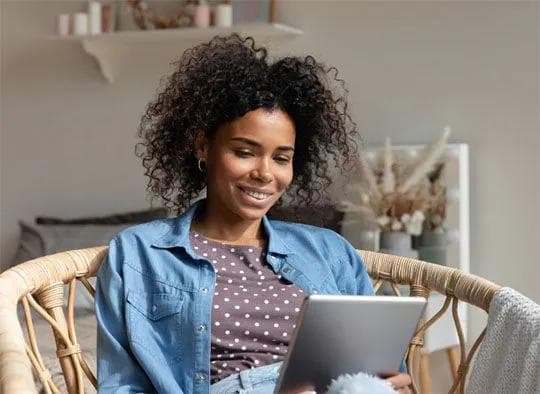 Happy person using Emburse Certify on tablet