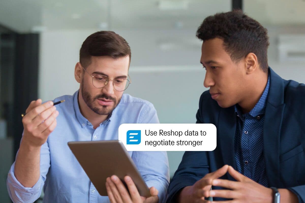 Two men looking at a tablet with a text overlay that reads: "Use Reshop data to negotiate stronger."