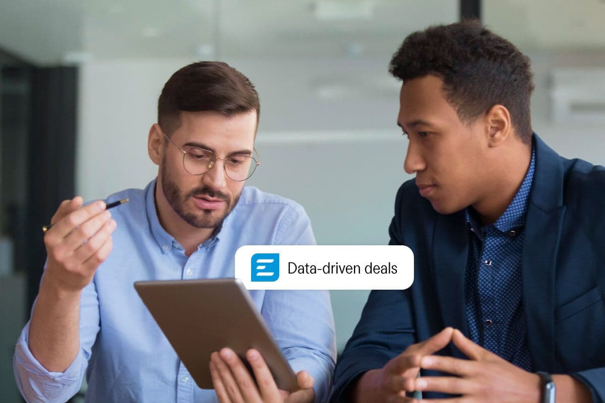 two men are looking at a tablet together .