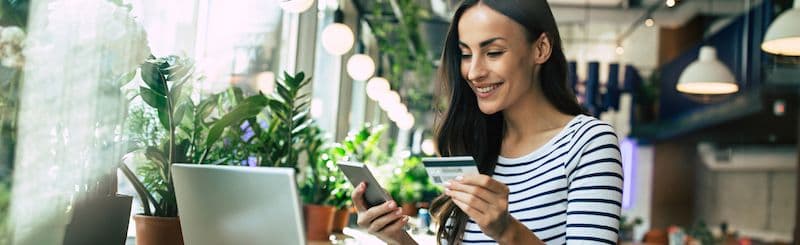 Happy person using Emburse Cards solutions