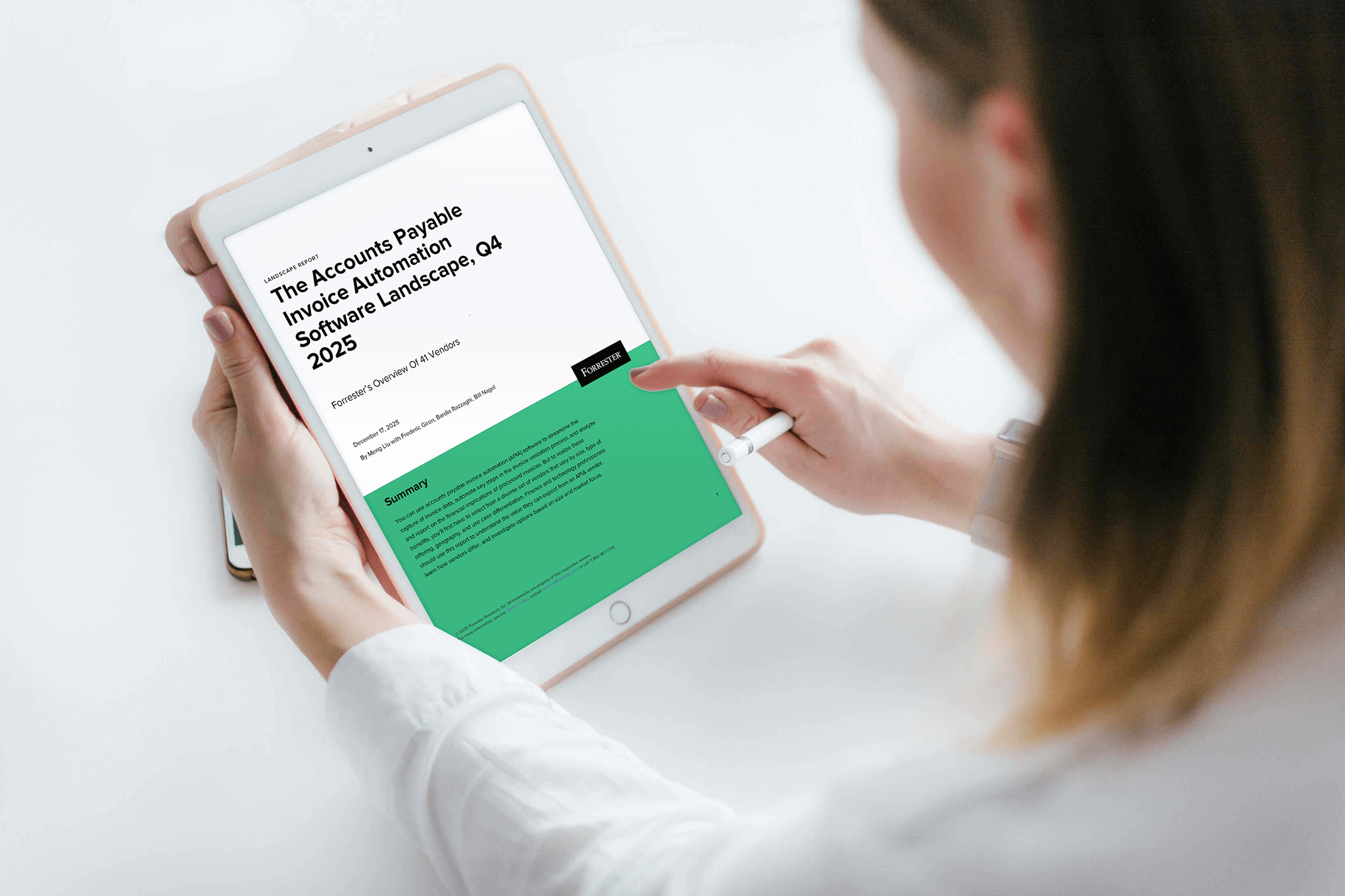A person holds a tablet displaying a report titled "The Accounts Payable Invoice Automation Software Landscape, Q4 2025" and interacts with it using a stylus.