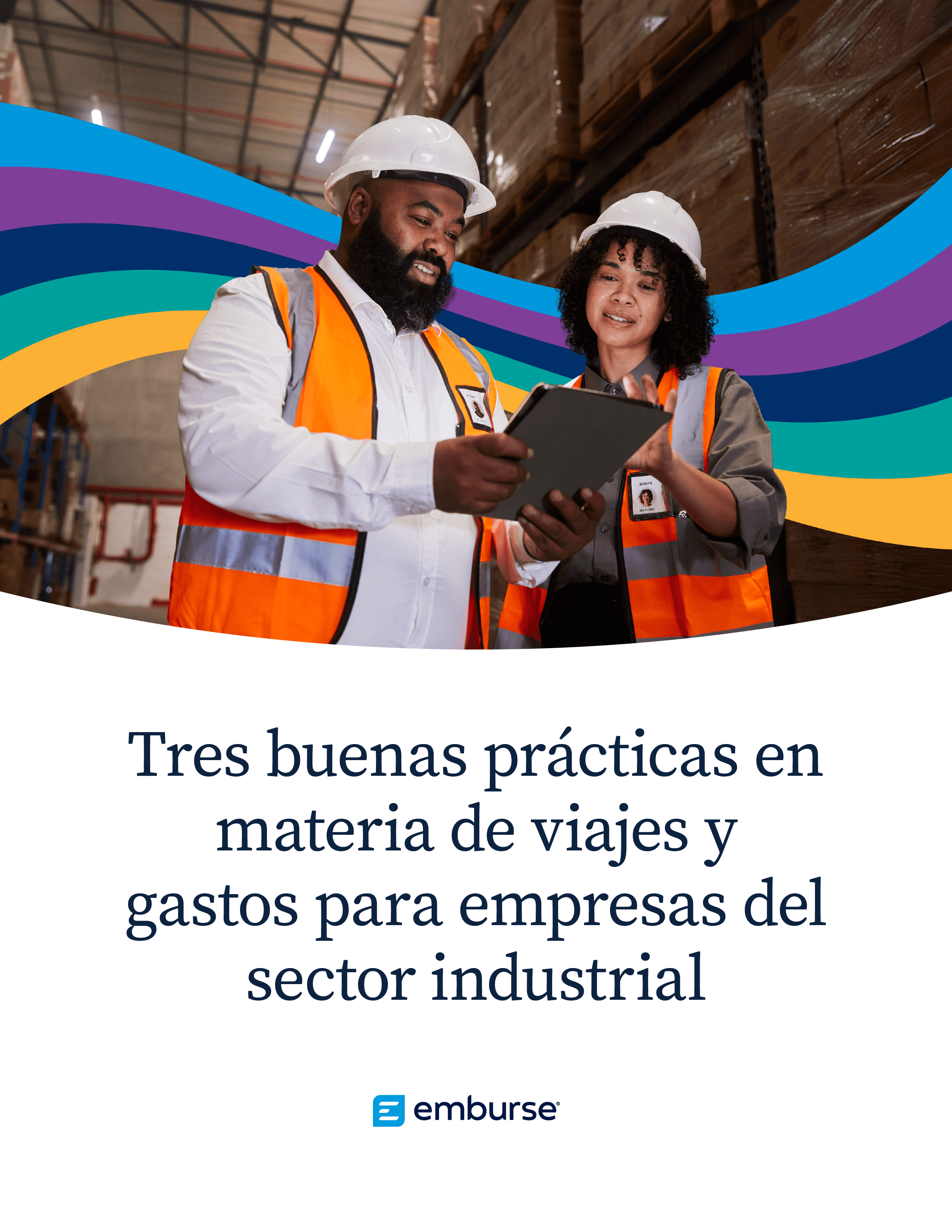 Two industrial workers in hard hats and safety vests discussing content on a tablet in a warehouse.