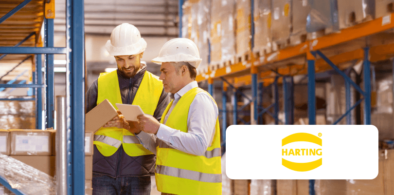 Man and woman in business attire discussing content on a tablet.