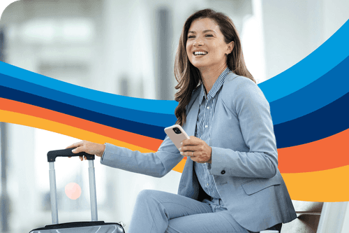 a woman in a suit sits with a suitcase and a cell phone