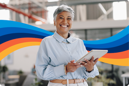 Happy employee holding tablet because her organization no longer uses a manual expense management system, and now uses Emburse solutions to automate their expense management process