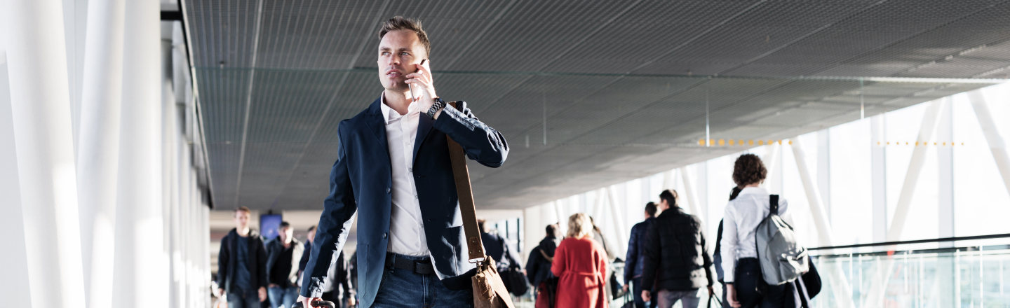 Corporate traveler in suit talking on phone