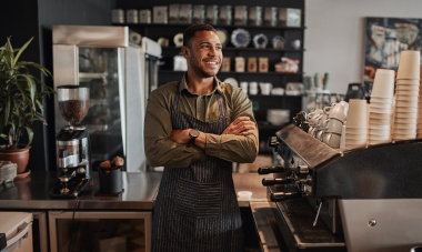 Barista smiling in his coffee shop